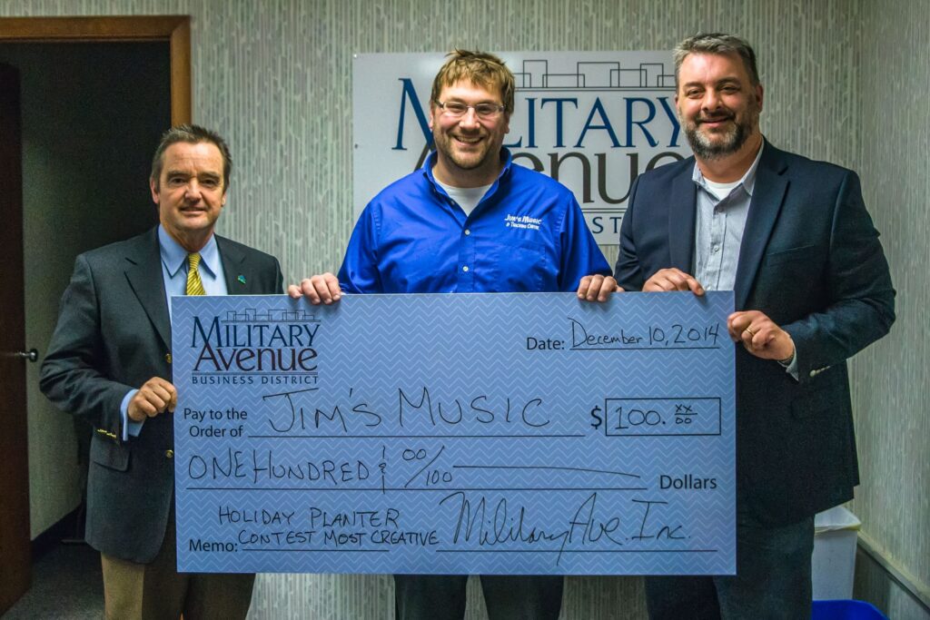 Jim Schmitt and community partners presenting a support check to a local organization.